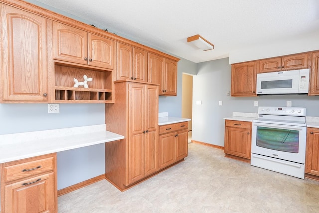 kitchen featuring white appliances and built in desk