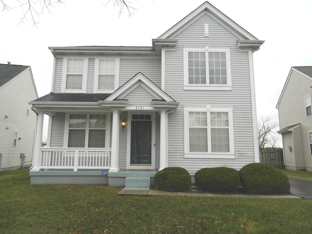 traditional home with a front yard and covered porch