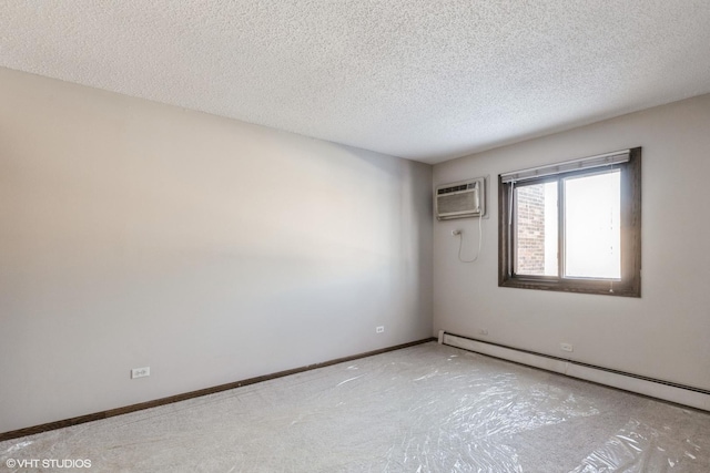 empty room featuring a baseboard radiator, an AC wall unit, and a textured ceiling