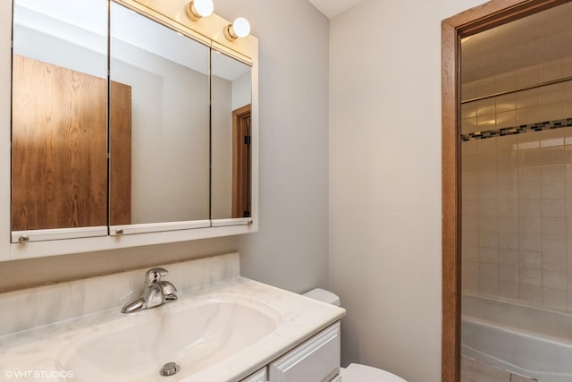 full bathroom with vanity, toilet, and tiled shower / bath combo