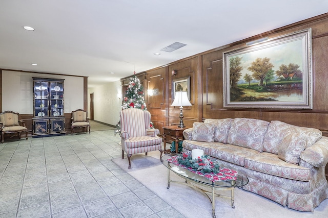 living room featuring crown molding and wood walls