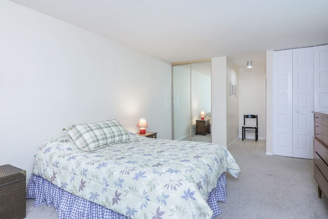 carpeted bedroom with multiple closets