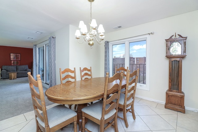 tiled dining space featuring a notable chandelier