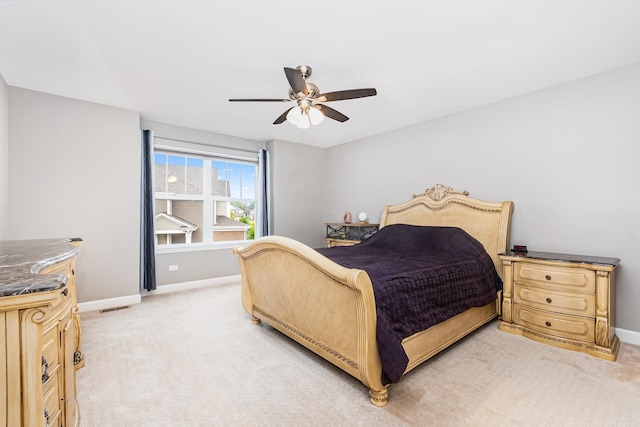 bedroom featuring light carpet and ceiling fan