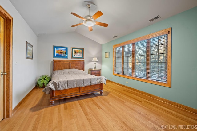 bedroom with lofted ceiling, light hardwood / wood-style floors, and ceiling fan