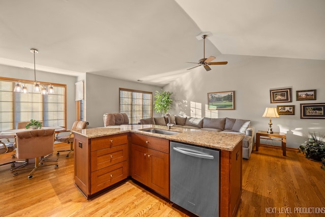 kitchen featuring dishwasher, sink, light hardwood / wood-style floors, and decorative light fixtures