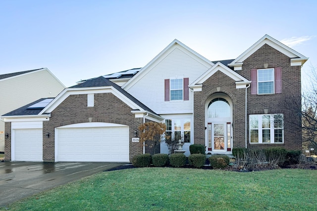 traditional home with a front yard, brick siding, driveway, and an attached garage