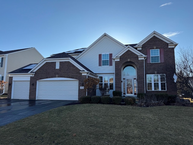 view of property featuring a garage and a front yard