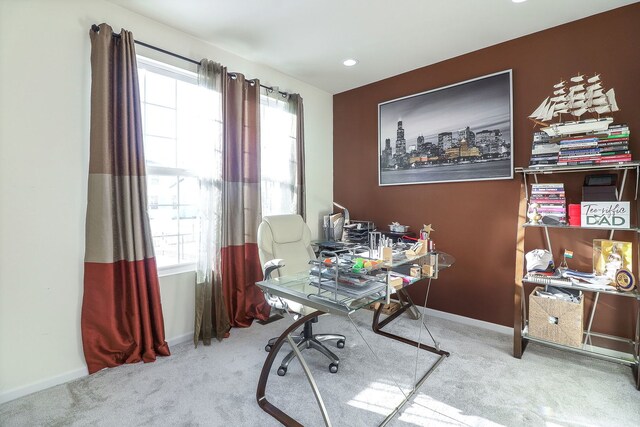 home office with plenty of natural light and light colored carpet