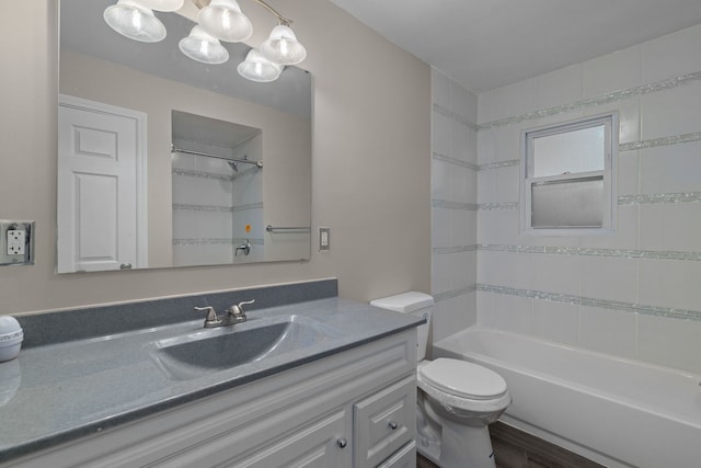 full bathroom with hardwood / wood-style flooring, vanity, toilet, and tiled shower / bath combo