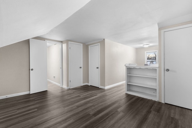 additional living space with lofted ceiling and dark hardwood / wood-style flooring