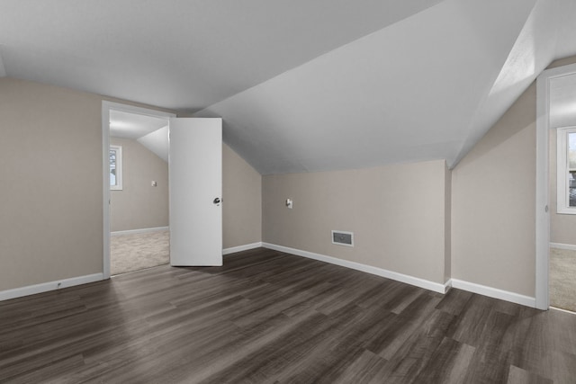 bonus room featuring lofted ceiling and dark hardwood / wood-style floors