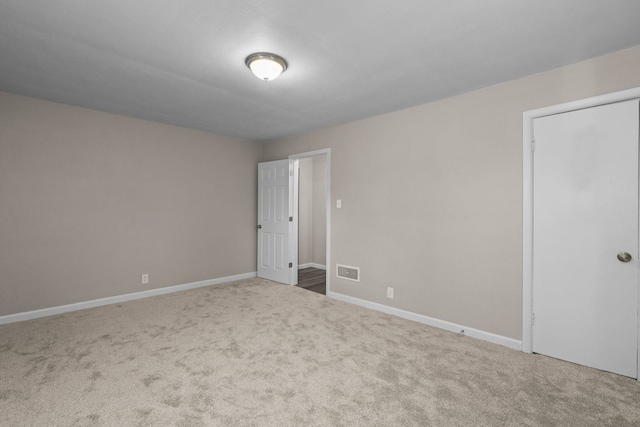 unfurnished room featuring carpet