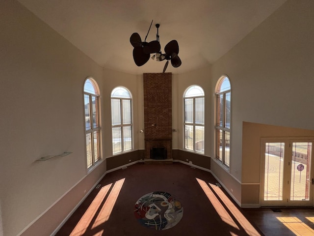 interior space featuring a brick fireplace and ceiling fan