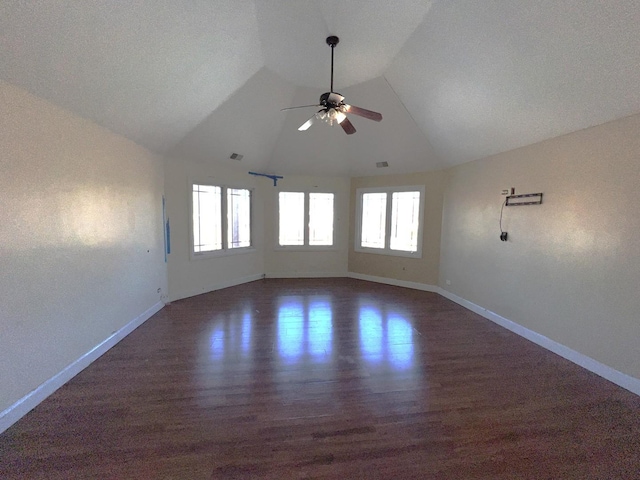 spare room with vaulted ceiling, dark hardwood / wood-style floors, and ceiling fan