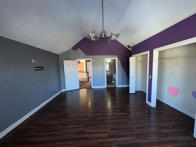 interior space featuring lofted ceiling and dark wood-type flooring