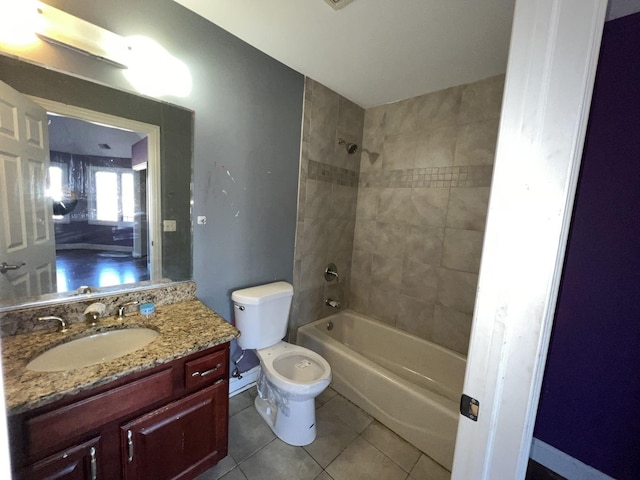 full bathroom featuring vanity, toilet, tiled shower / bath combo, and tile patterned flooring