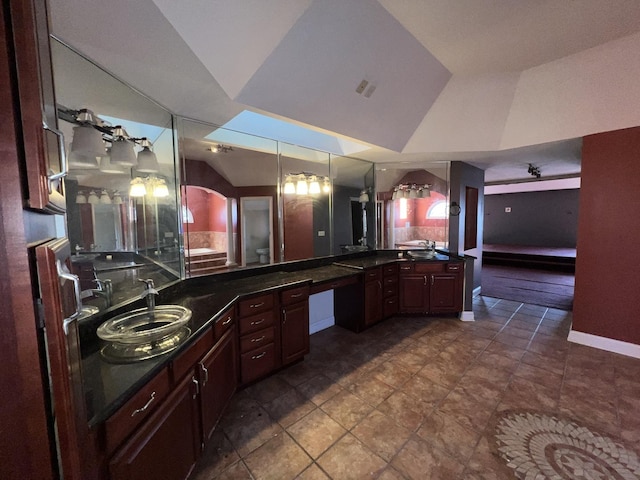 bathroom with lofted ceiling and sink