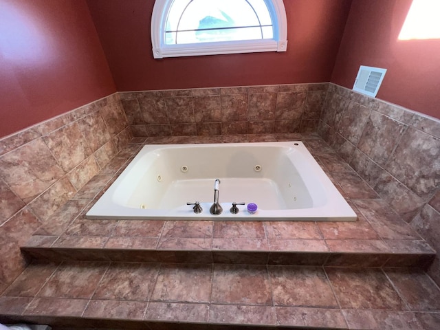 bathroom with a relaxing tiled tub