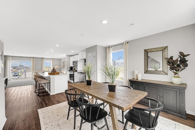 dining room with a wealth of natural light and dark hardwood / wood-style flooring