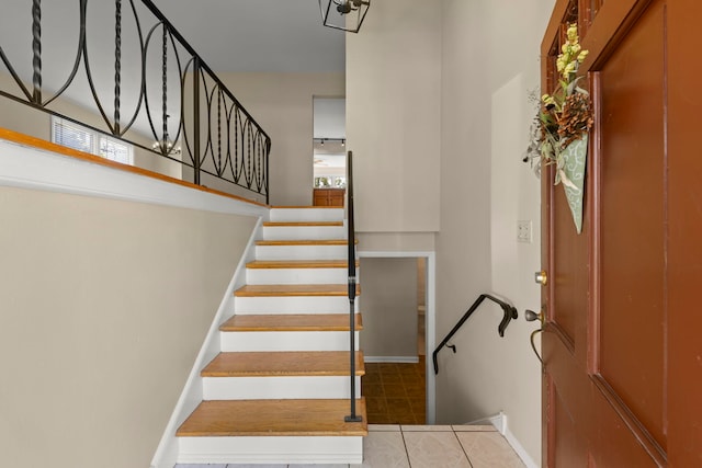 stairs featuring tile patterned floors and a healthy amount of sunlight