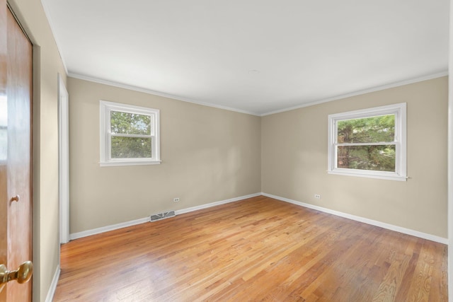 unfurnished room featuring crown molding, a healthy amount of sunlight, and light hardwood / wood-style floors