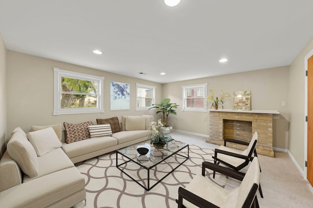 living room featuring a fireplace and light carpet