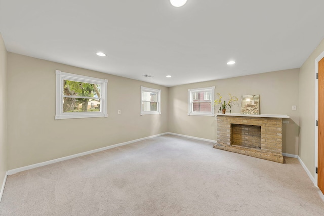 unfurnished living room featuring a fireplace and light carpet