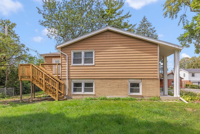 back of property with a wooden deck and a lawn