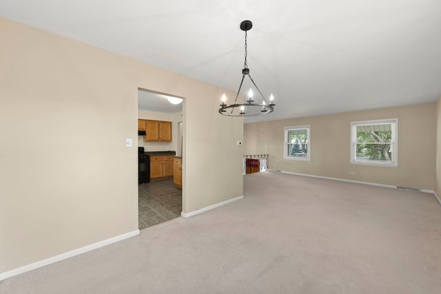 empty room with light carpet and a chandelier