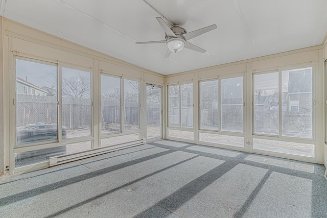 unfurnished sunroom with ceiling fan