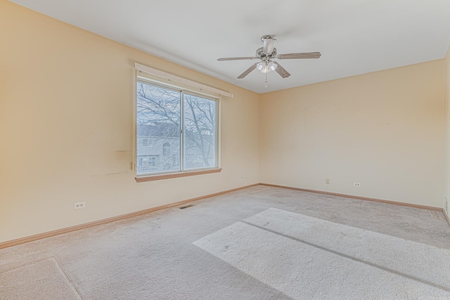 carpeted spare room with ceiling fan