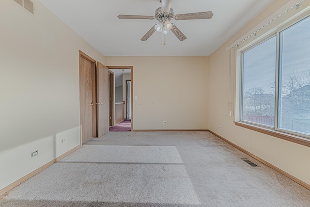 carpeted empty room with ceiling fan