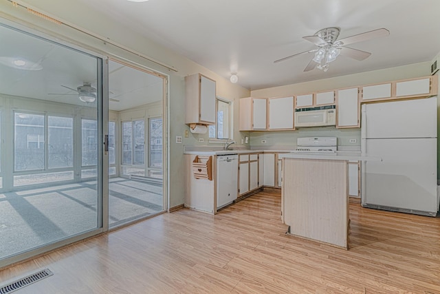 kitchen featuring white cabinetry, light wood-type flooring, and white appliances