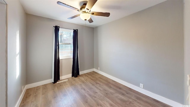 empty room with light hardwood / wood-style flooring and ceiling fan