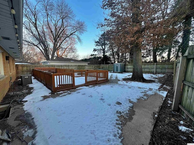 yard covered in snow featuring central AC