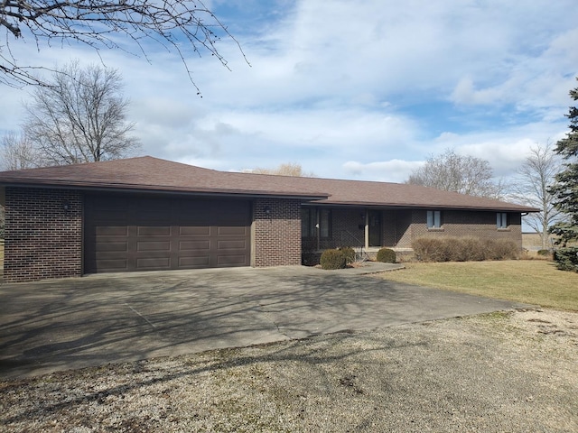 ranch-style house with a garage and a front yard