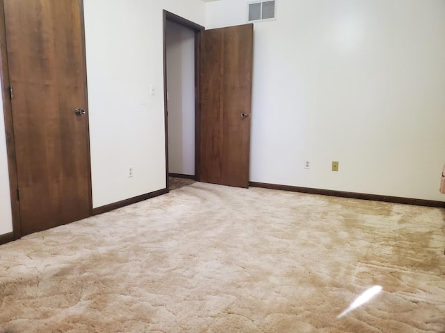 spare room with light colored carpet