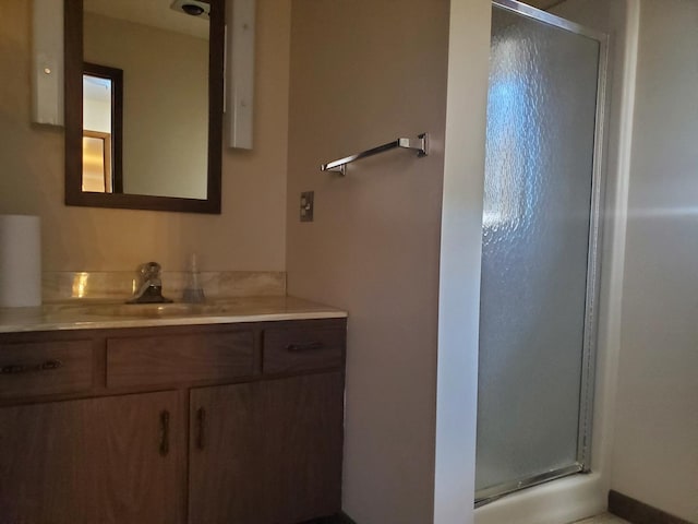 bathroom featuring vanity and a shower with shower door