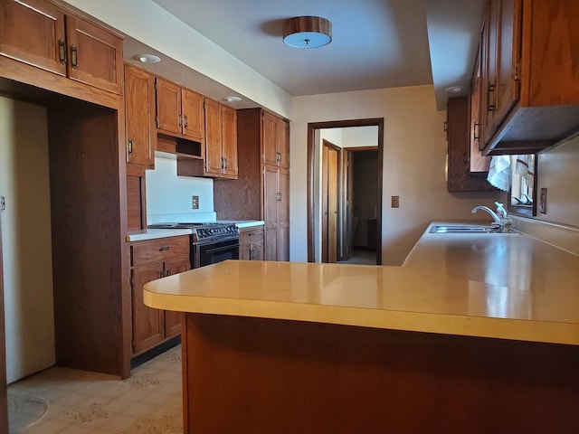 kitchen with stove, sink, and kitchen peninsula