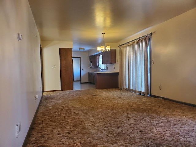 kitchen with a chandelier, sink, and light carpet