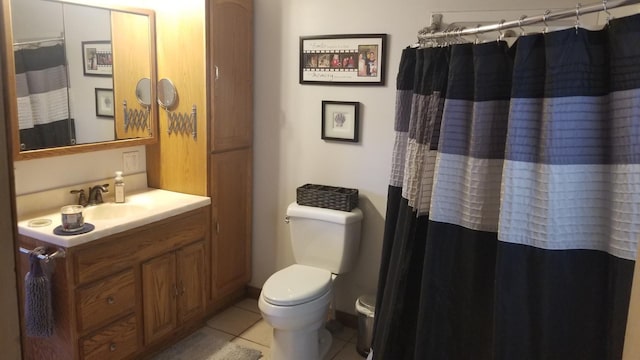 full bathroom featuring a shower with shower curtain, vanity, toilet, and tile patterned floors