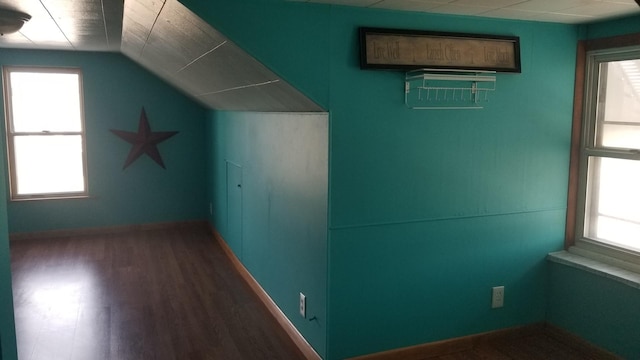 bonus room with lofted ceiling, baseboards, and wood finished floors