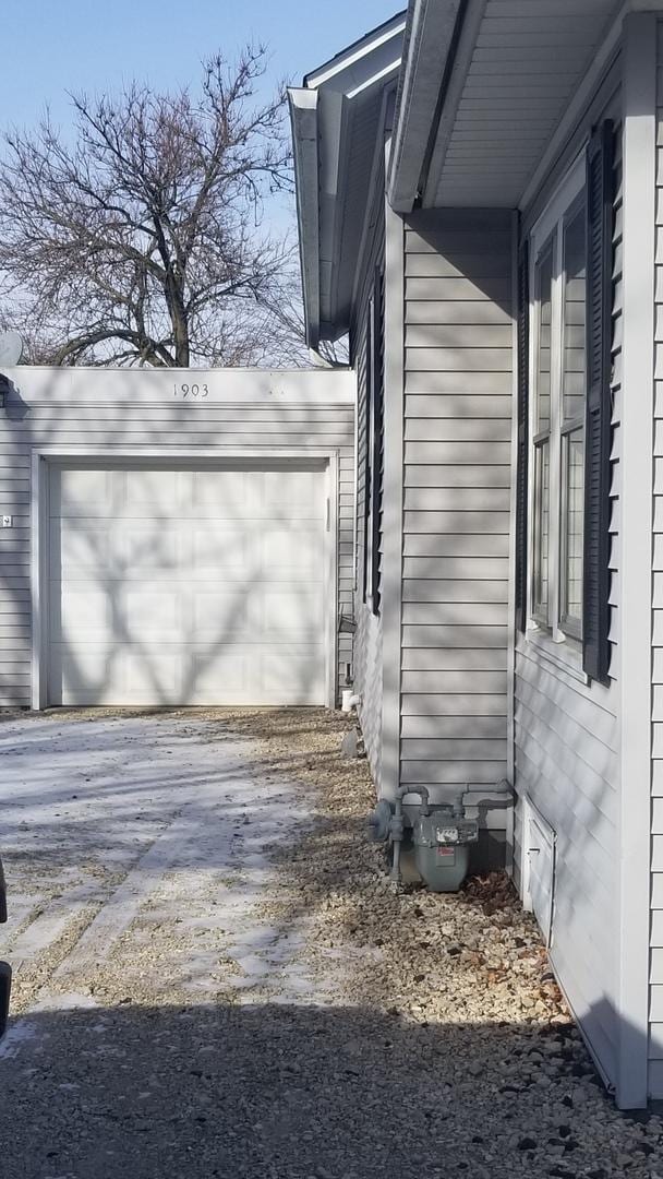 view of side of home featuring aphalt driveway