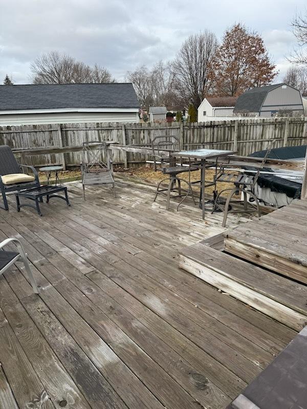 wooden deck featuring outdoor dining area and fence