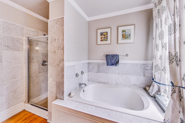 full bath featuring a garden tub, a shower stall, crown molding, and wood finished floors