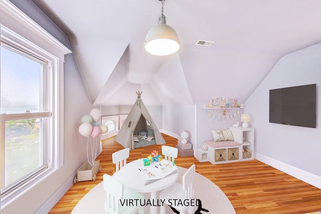 recreation room with visible vents, vaulted ceiling, light wood-style flooring, and baseboards