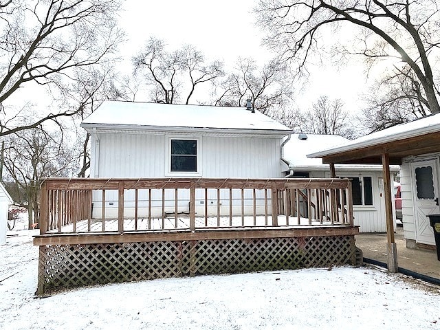 snow covered property with a deck