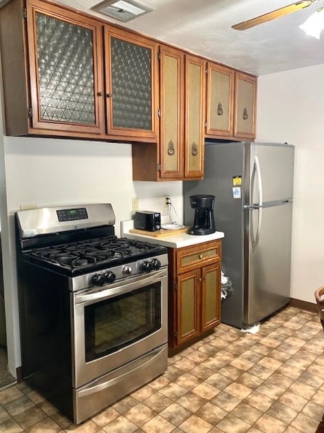 kitchen with ceiling fan and appliances with stainless steel finishes