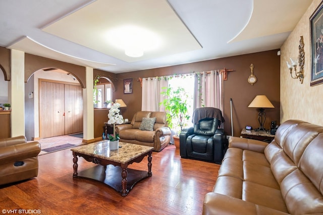 living room featuring hardwood / wood-style flooring and a healthy amount of sunlight